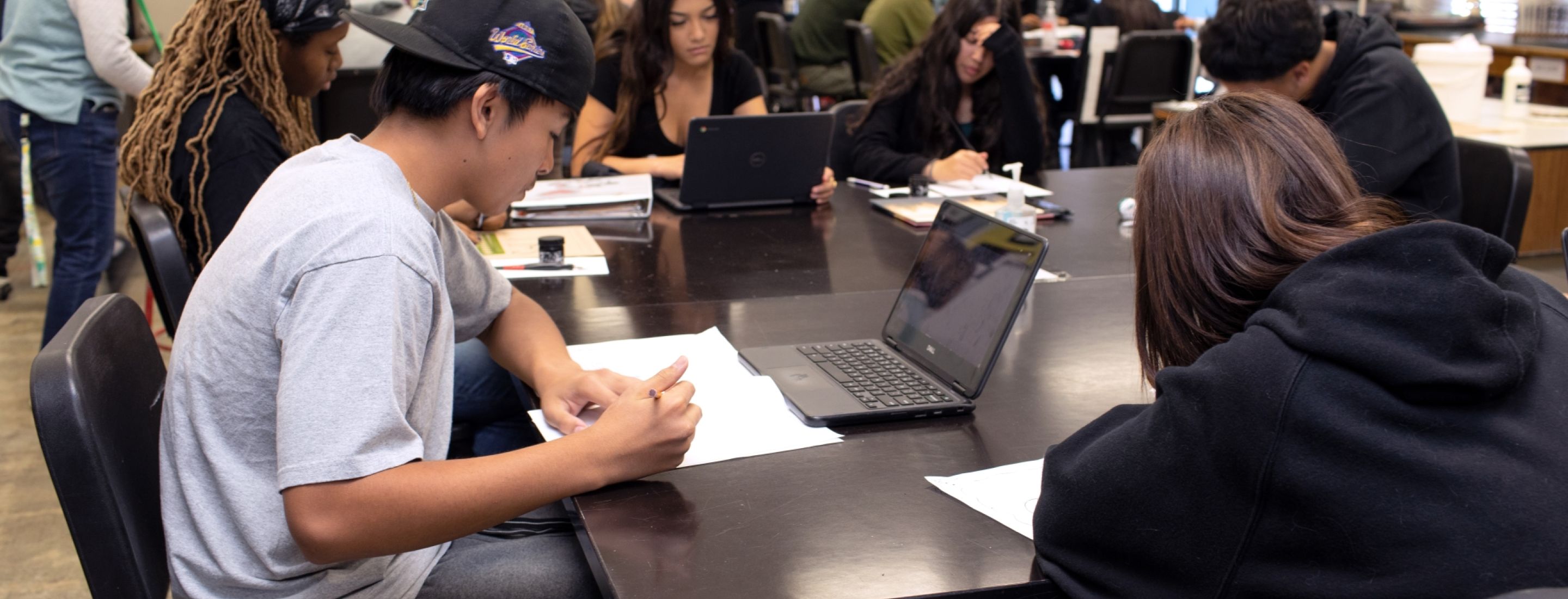 Students sitting at desks with laptops.